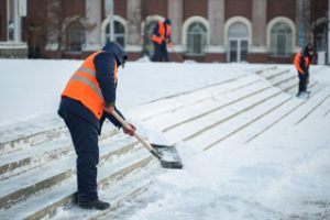 Construction shoveling snow